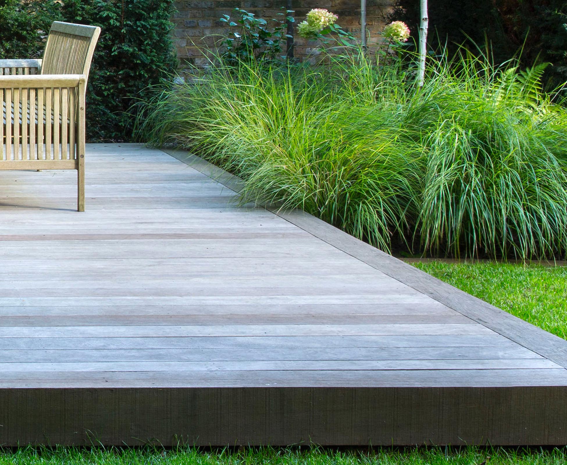 Detail of the shadow gap under the hardwood timber deck in this Hampstead Heath garden, North London.