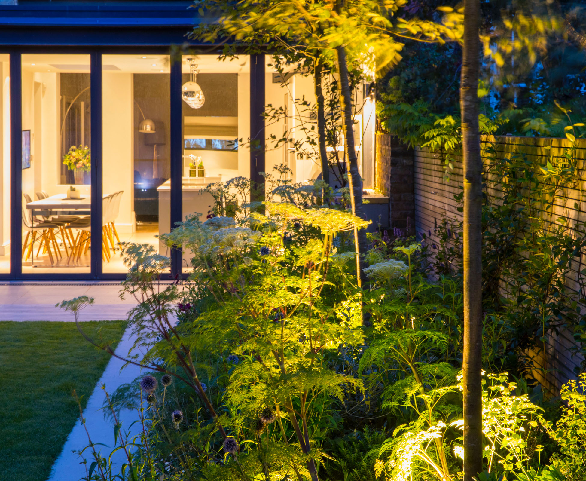 The view from this Islington Garden is stunning as the LED spot lights are in harmony with the interior lighting. The soft colours of the planting seem to be dancing in the night.