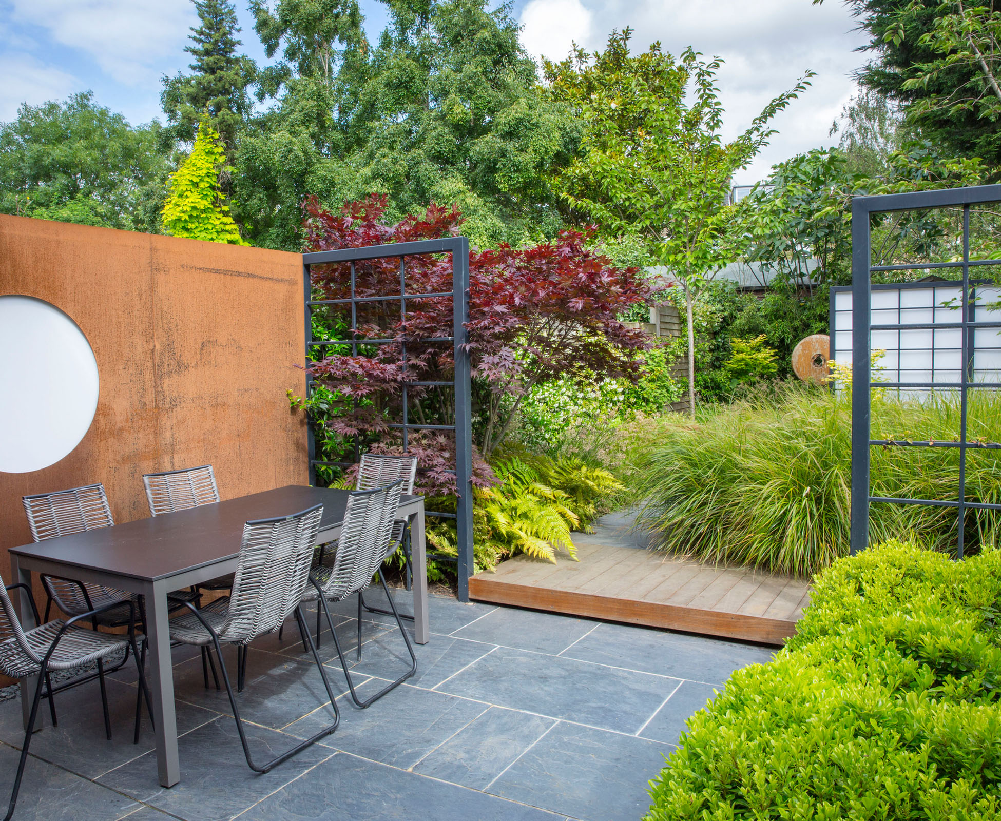 A Corten Steel Moon window becomes a feature of this garden. 